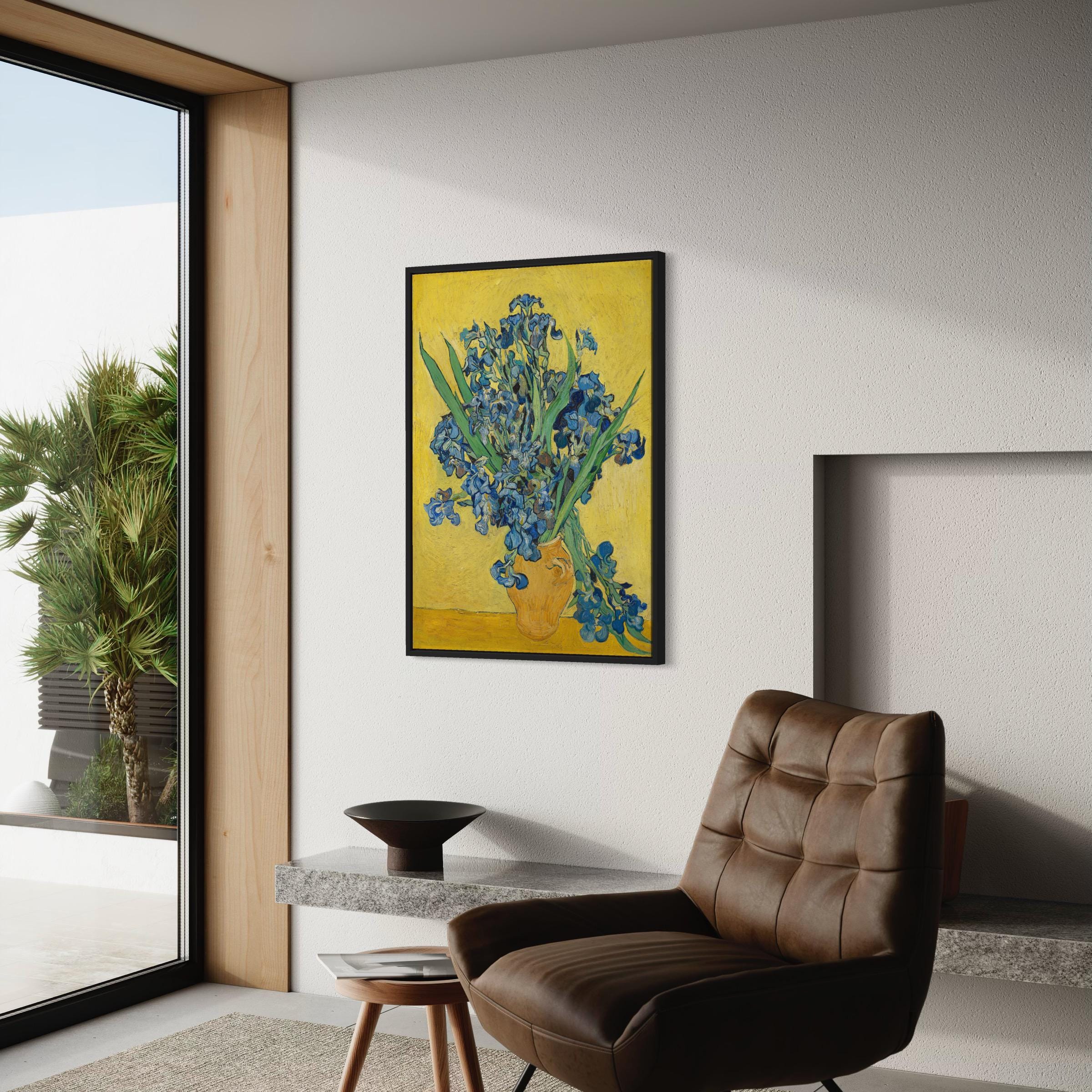May include: A painting of a bouquet of blue irises in a yellow vase on a yellow background. The painting is framed in black and displayed on a white wall.