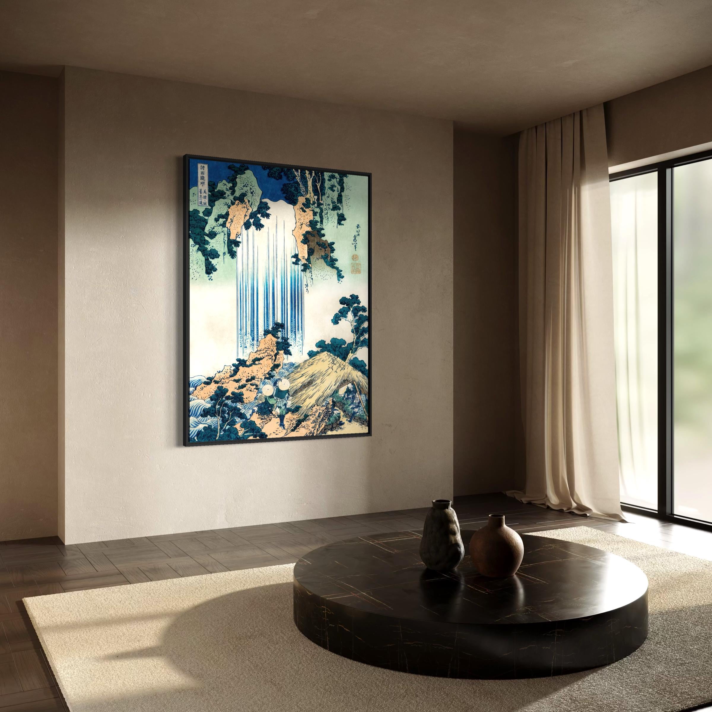 May include: A framed print of a Japanese landscape featuring a waterfall cascading down a rocky mountain. The artwork uses shades of blue, green, and beige. The print is displayed in a modern living room setting with a round coffee table and neutral-toned decor.