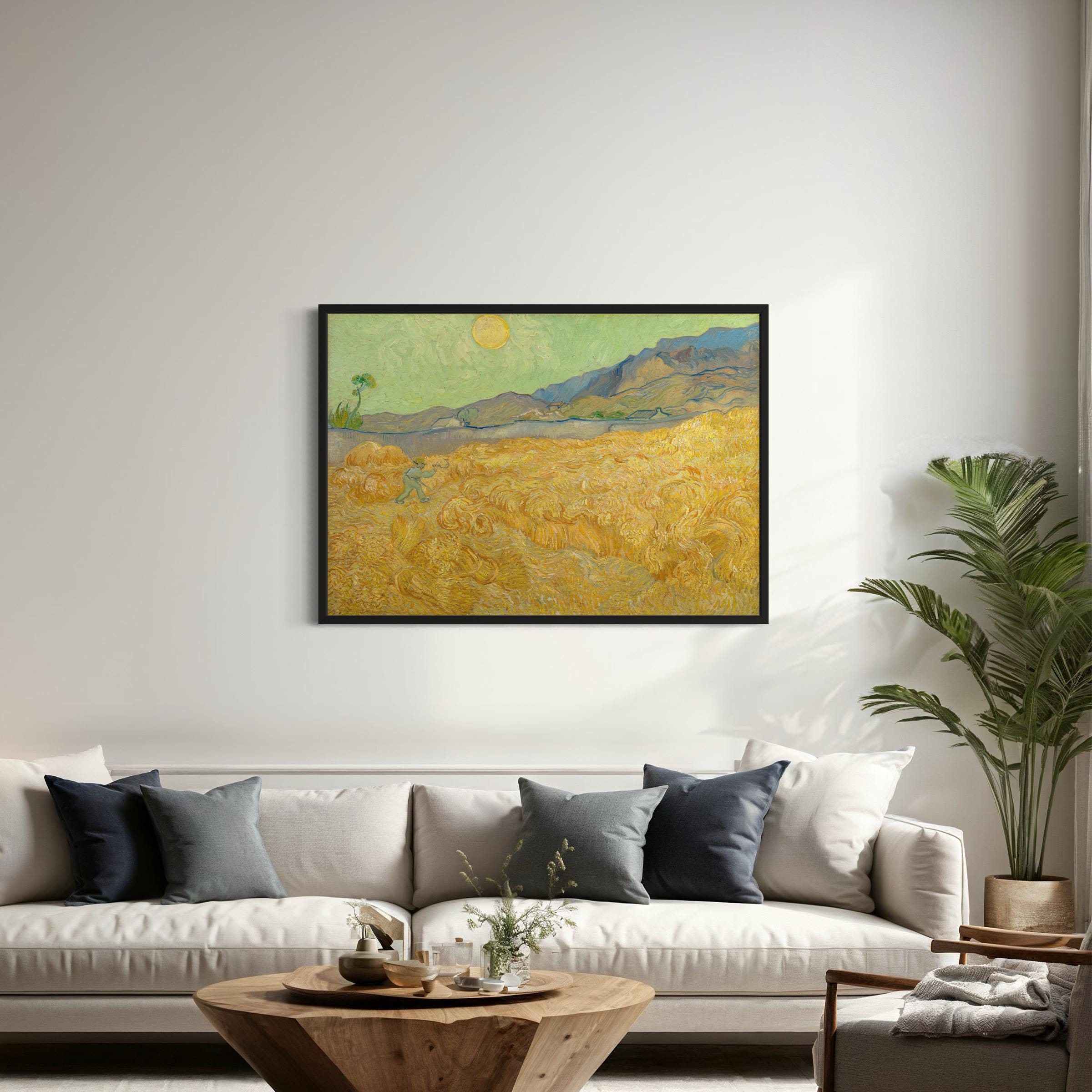 May include: A framed painting of a landscape with a yellow field, a blue mountain range in the background, and a small tree in the foreground. The sky is a light green color and there is a bright yellow sun in the sky. The painting is in a black frame and is hanging on a white wall.