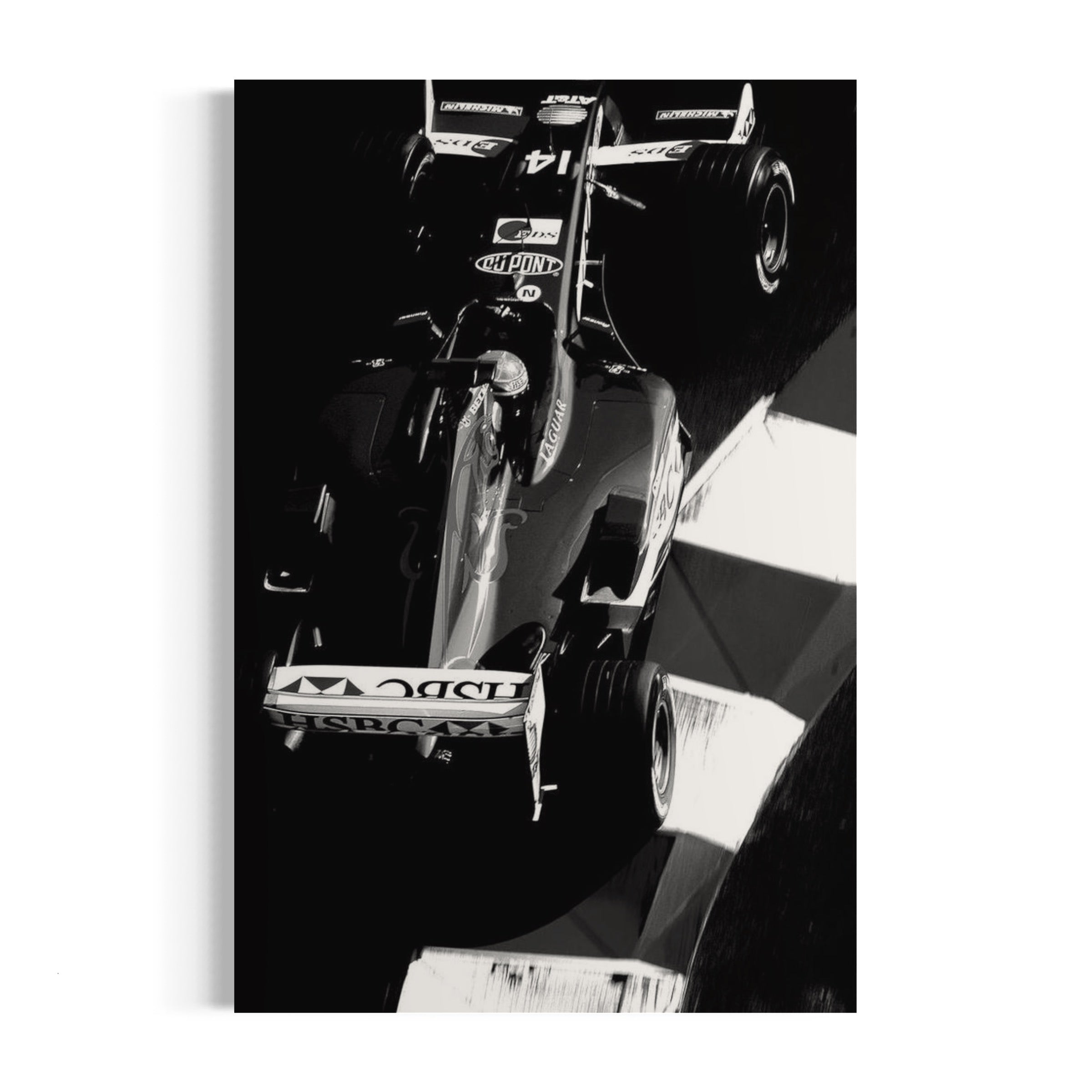 a black and white photo of a man driving a race car