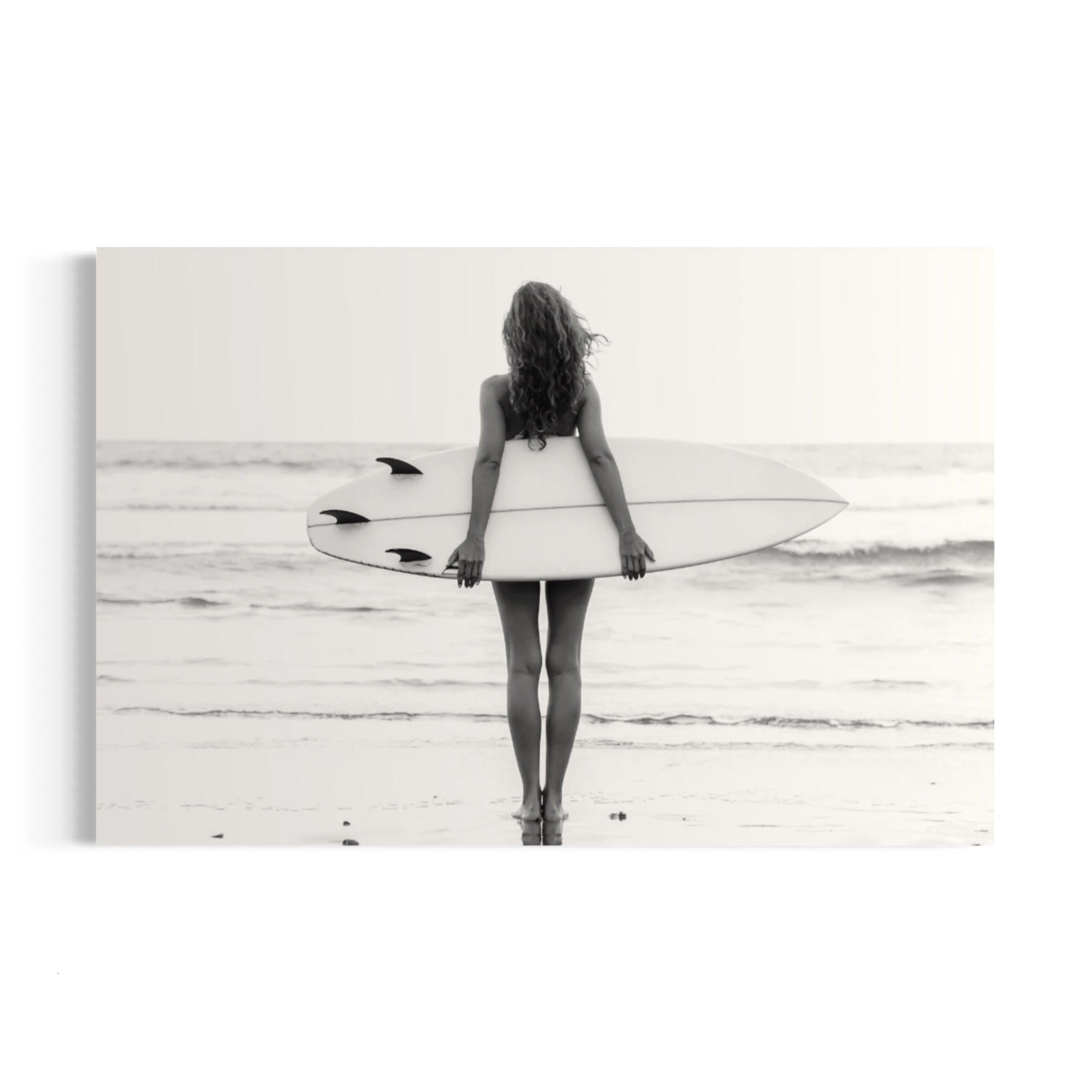a woman holding a surfboard on top of a beach