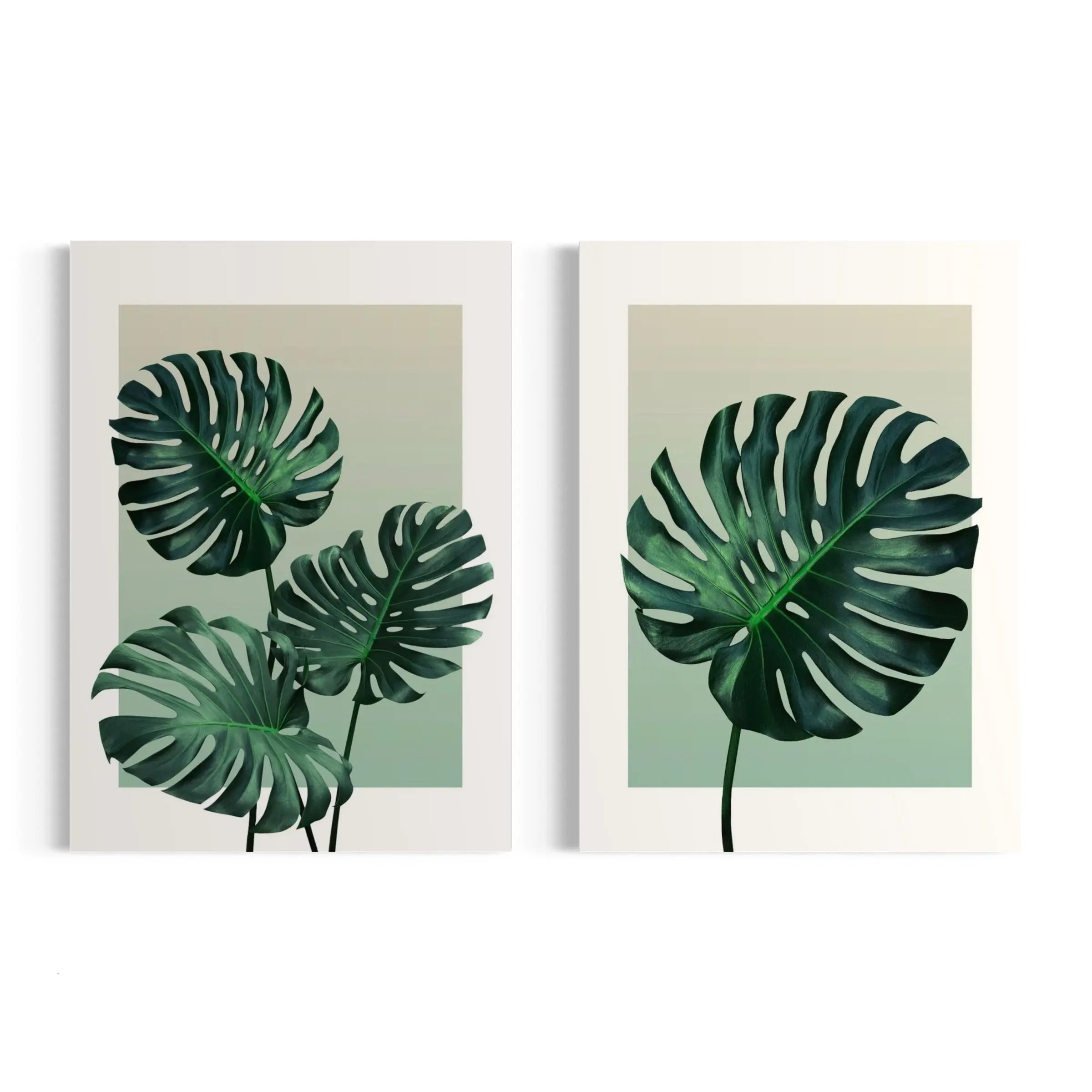 a couple of paintings of leaves on a wall