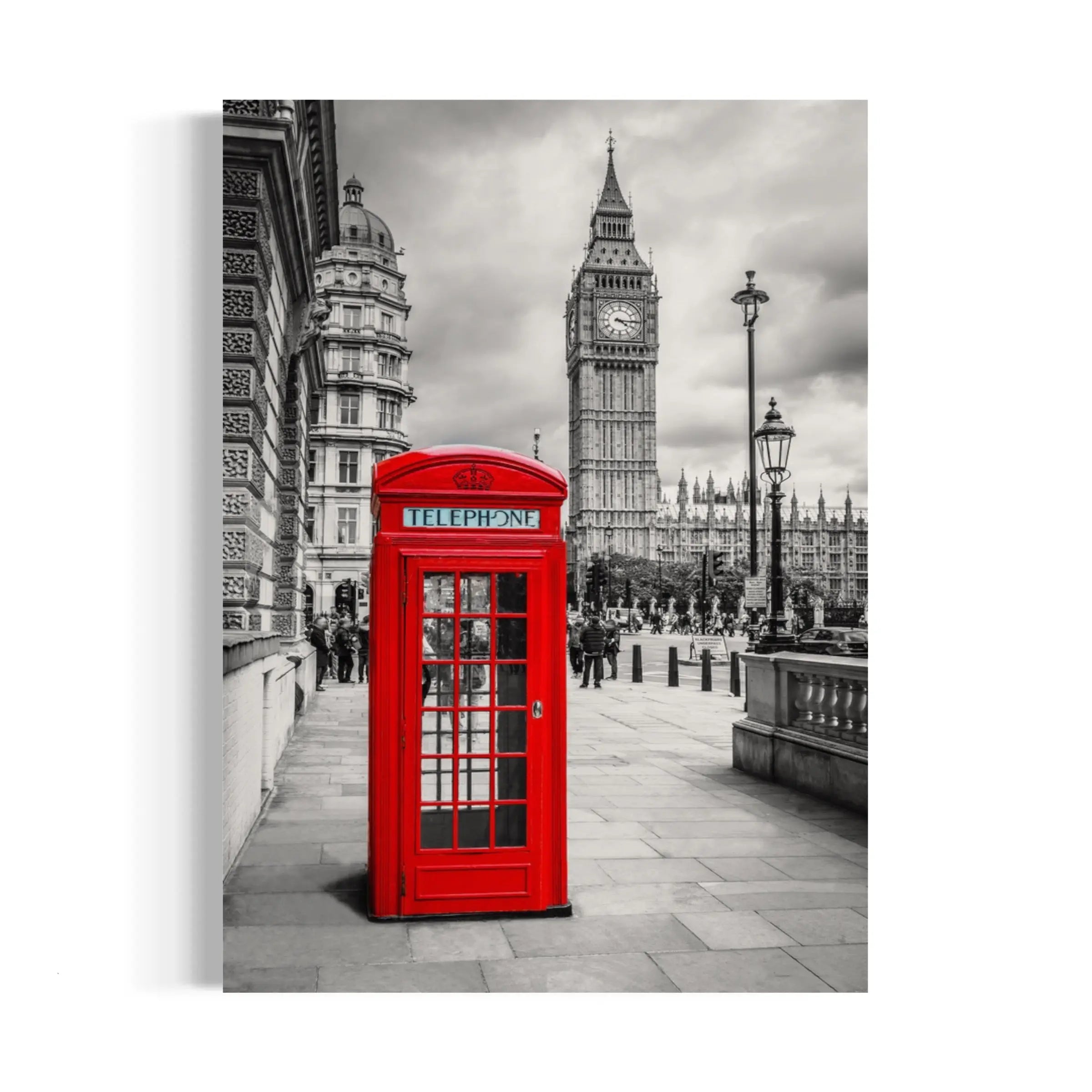 a red phone booth sitting on the side of a road