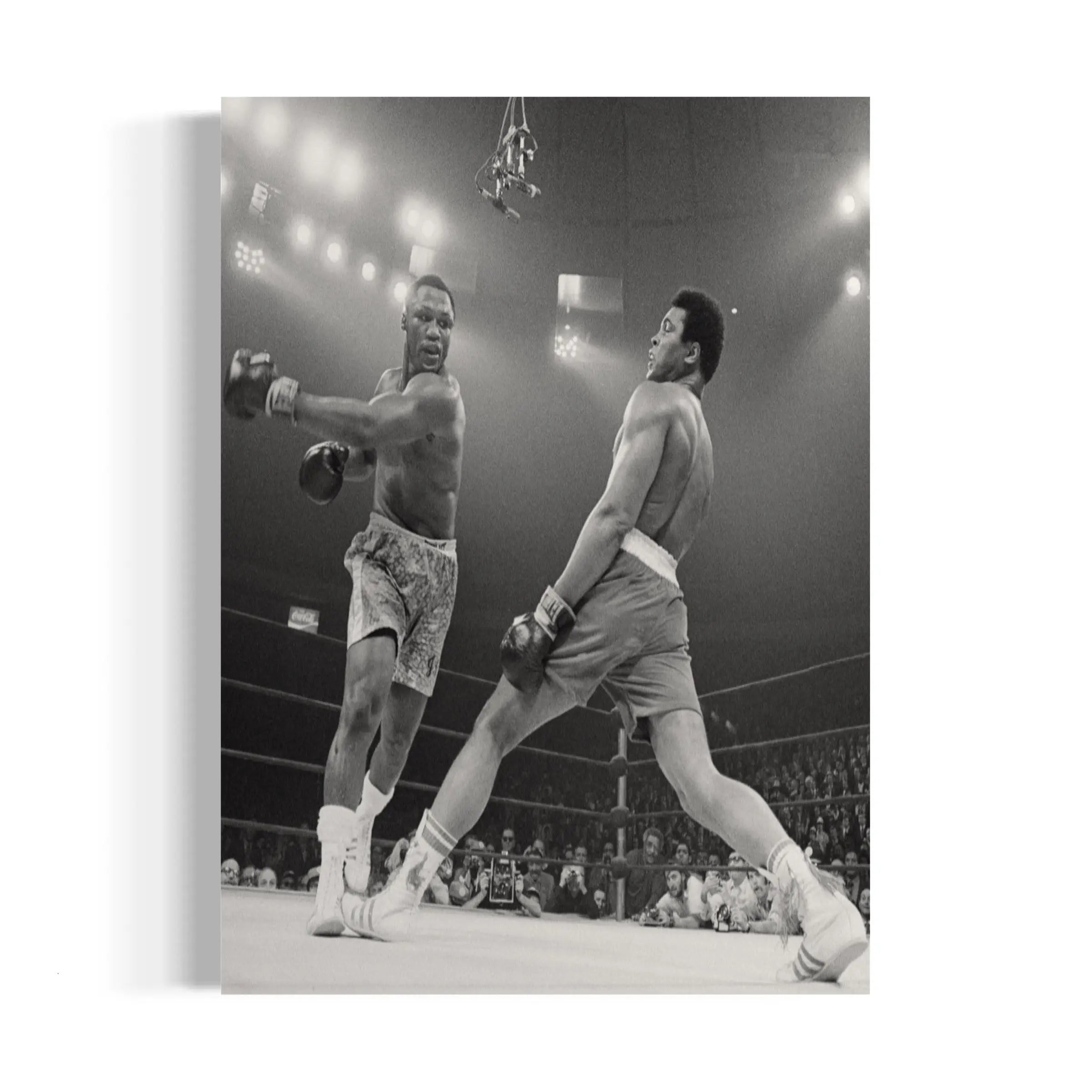 a black and white photo of two men in a boxing ring