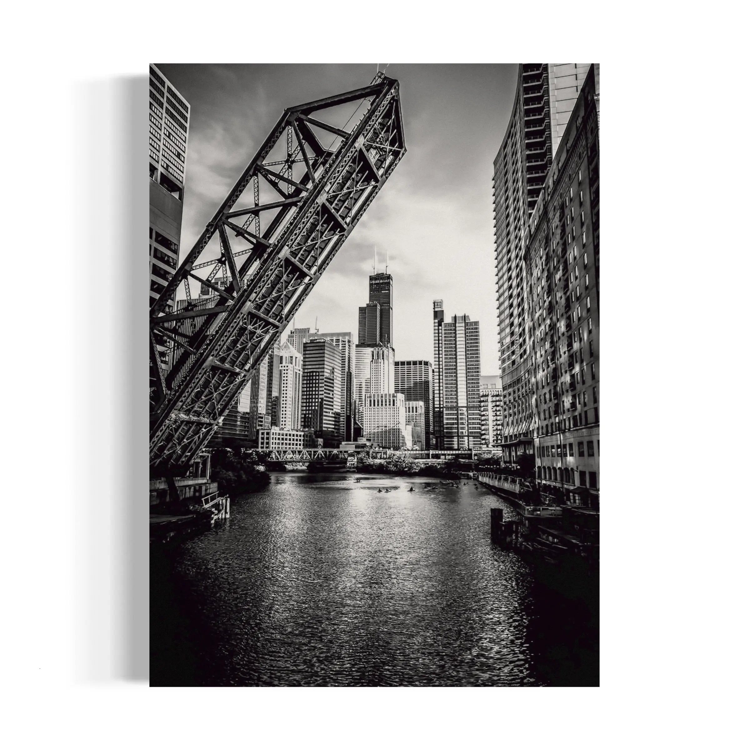 a black and white photo of a bridge over a river