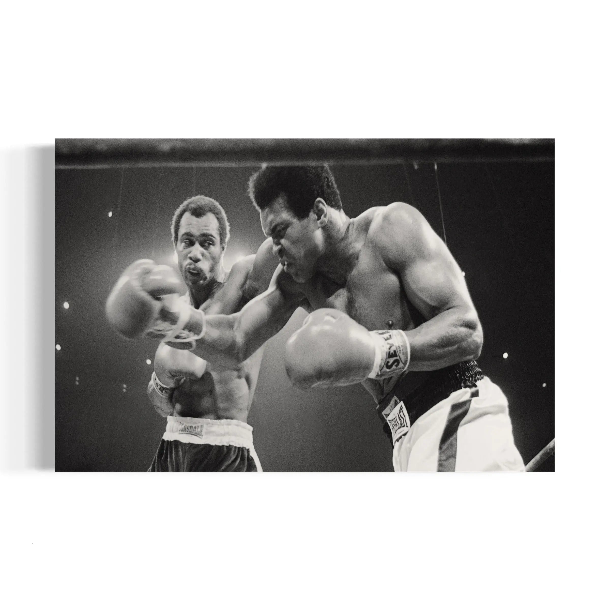 a black and white photo of two men boxing