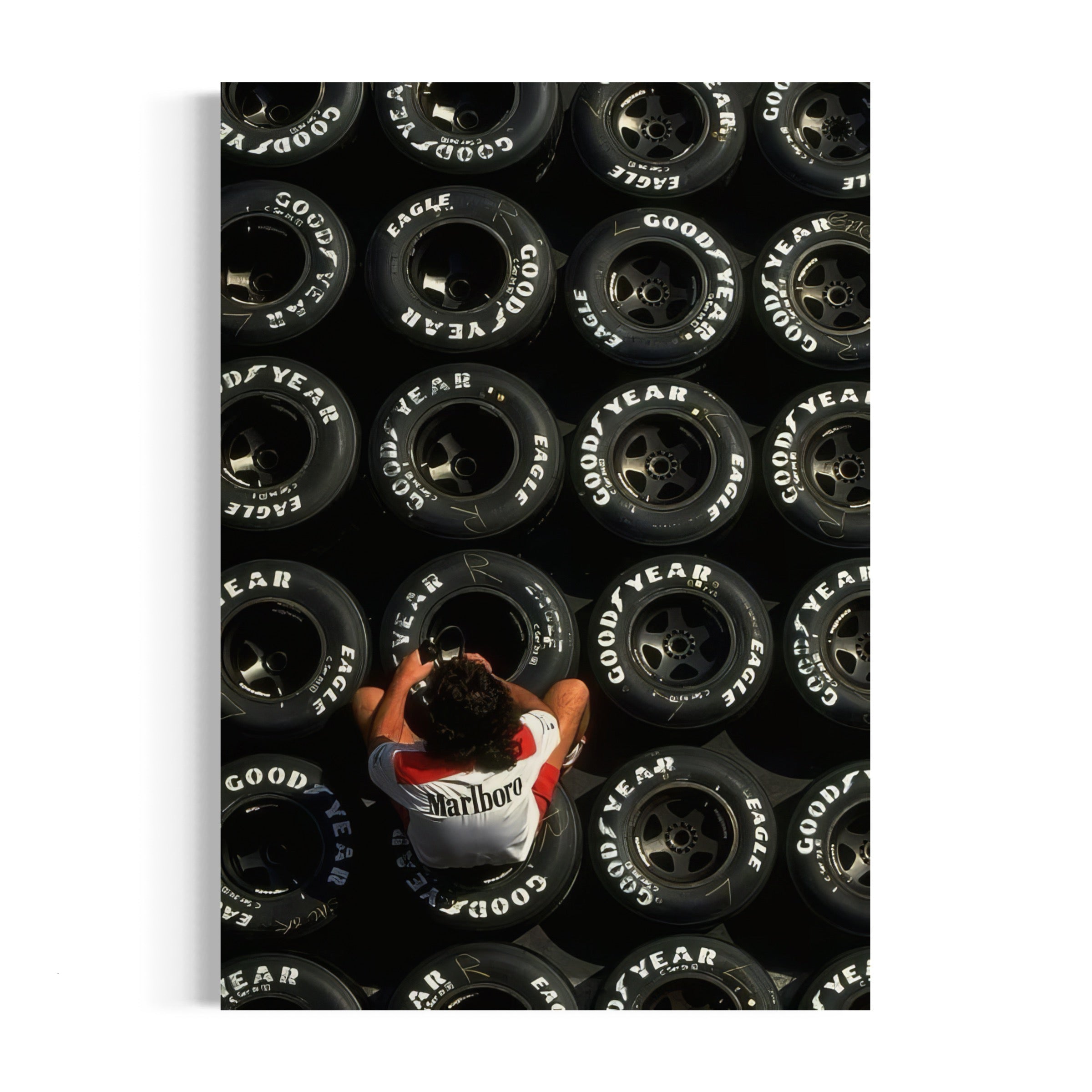 a person standing in front of a pile of tires