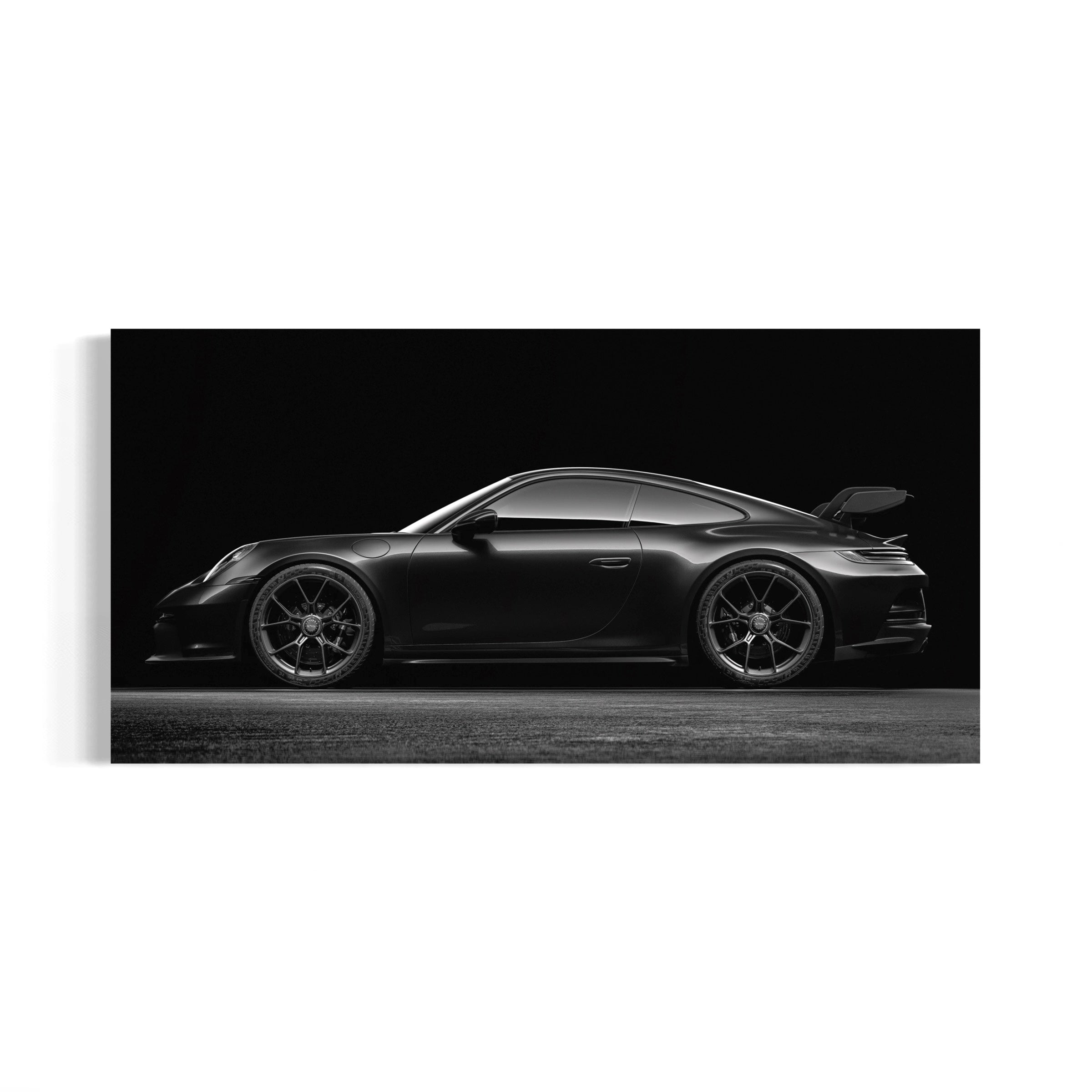 A sleek, black sports car is captured in a dramatic black and white photograph, showcasing its powerful design and aerodynamic shape.
