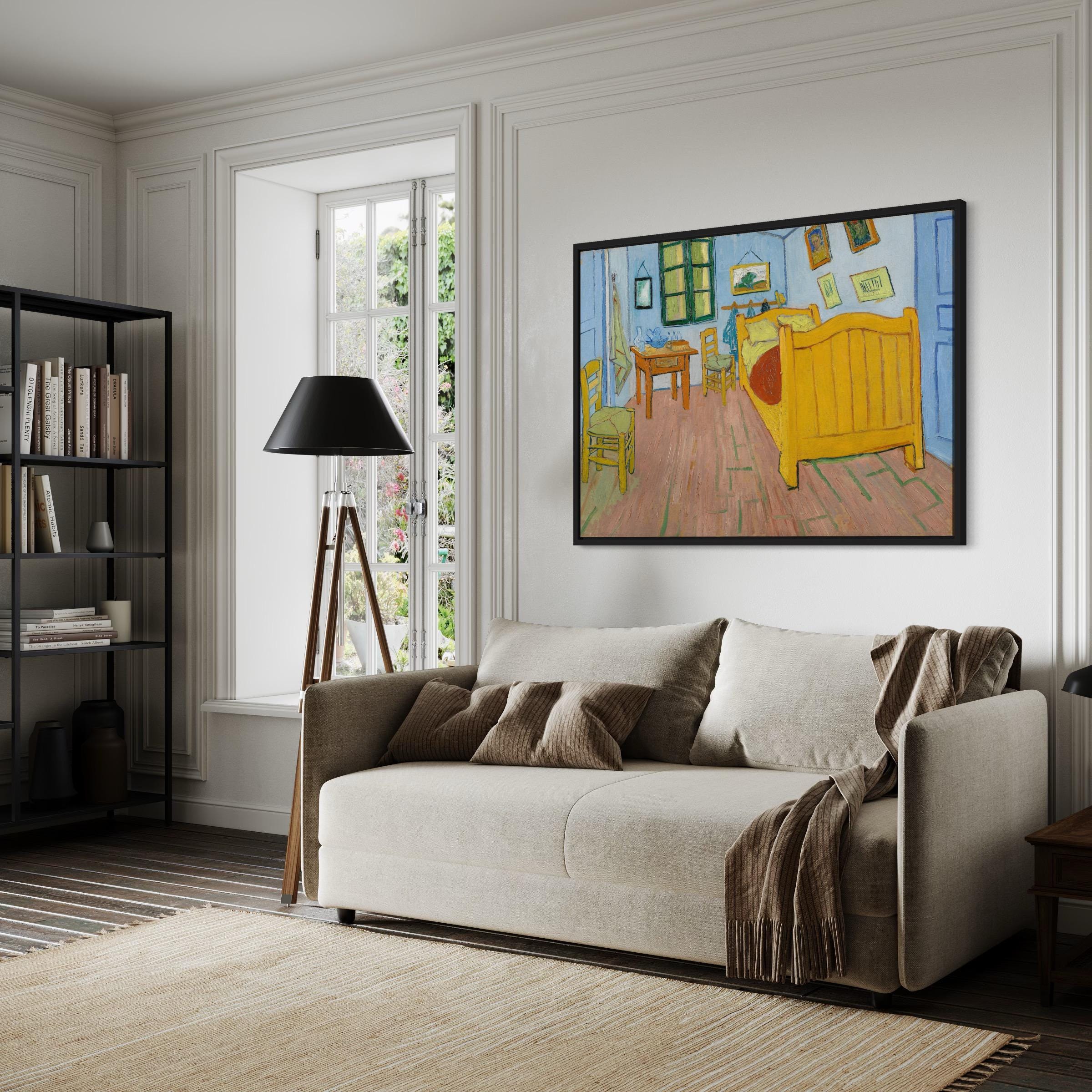 May include: A framed painting of a bedroom with a yellow bed, a blue wall, and a wooden floor. The painting is hanging on a white wall above a light gray couch with brown throw pillows and a brown blanket.